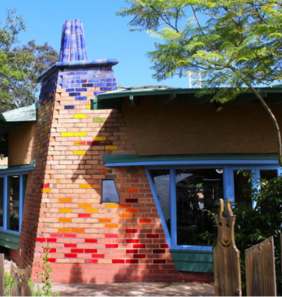 Brick building with triangular chimney with coloured bricks