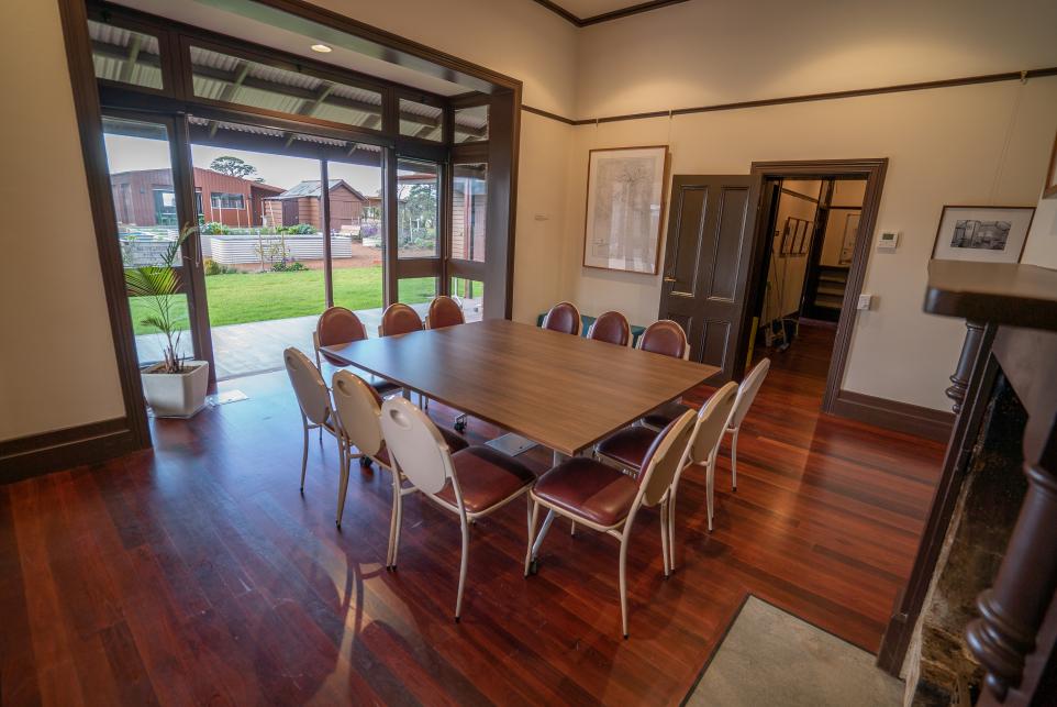 Meeting room with a square table in the centre with chairs around it