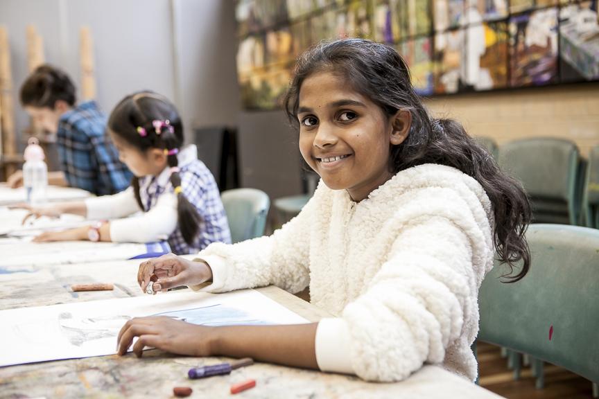 Image of child smiling in art studio 