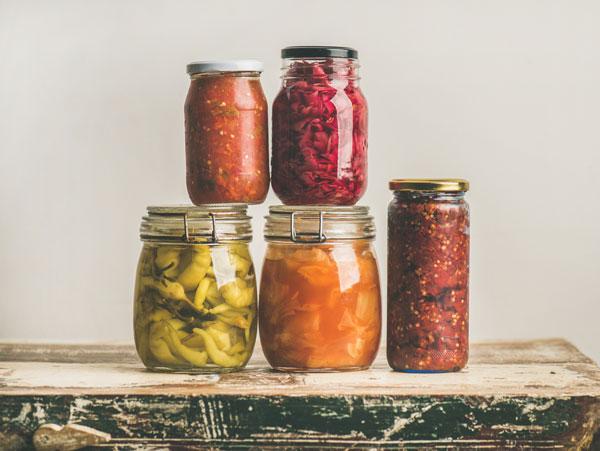 Image of five jars of fermented vegetables stacked on top of each other.