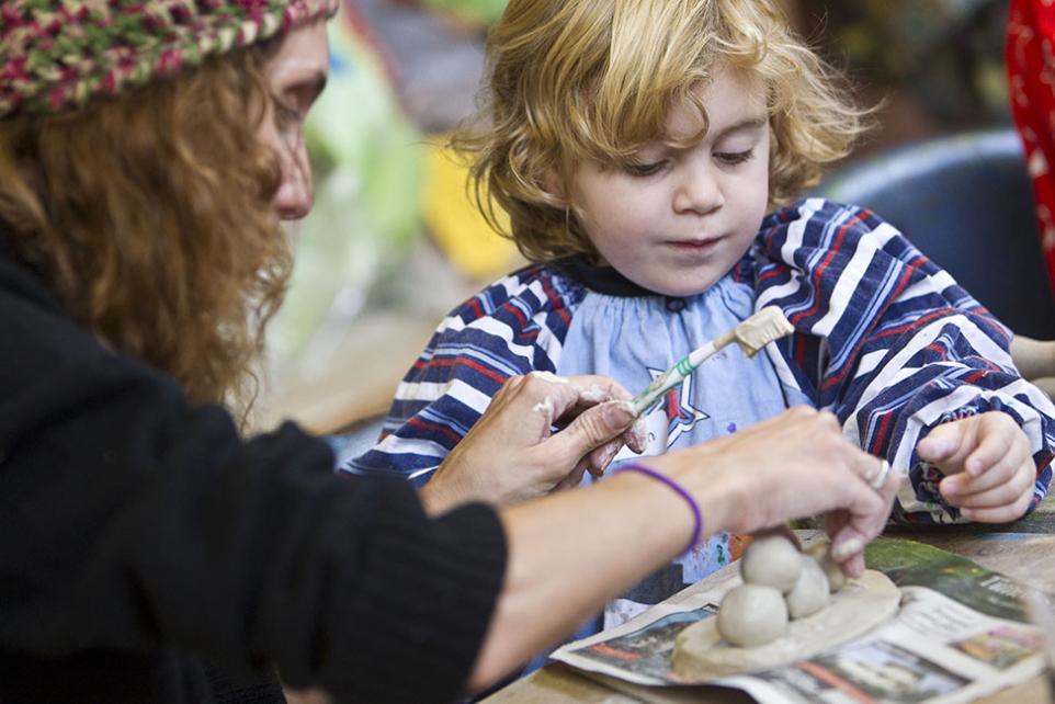 mother and child creating clay artwork.