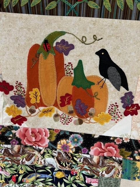 Still life with vegetables and a bird made from fabric.