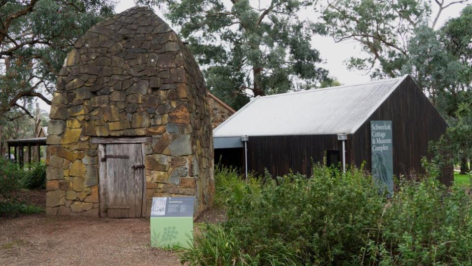 Stone smokehouse with museum building
