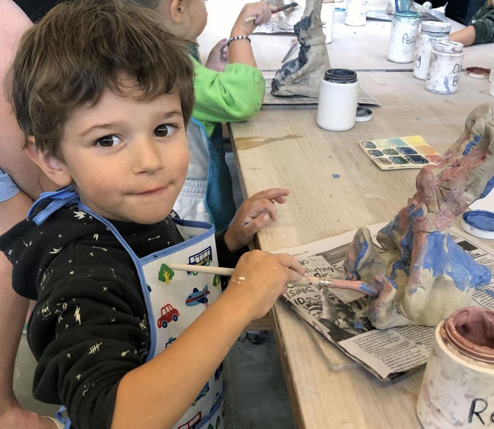 child painting clay bunny in BHCAC studio