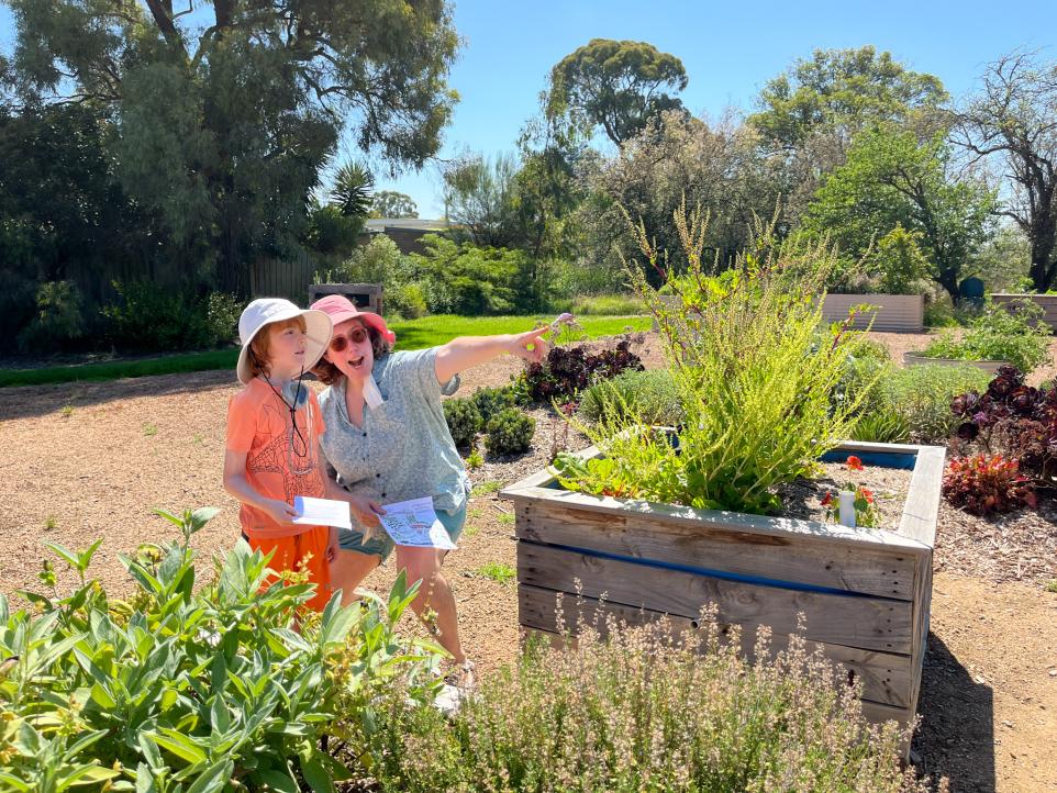 Strathdon House family in garden on treasure hunt, point to clues
