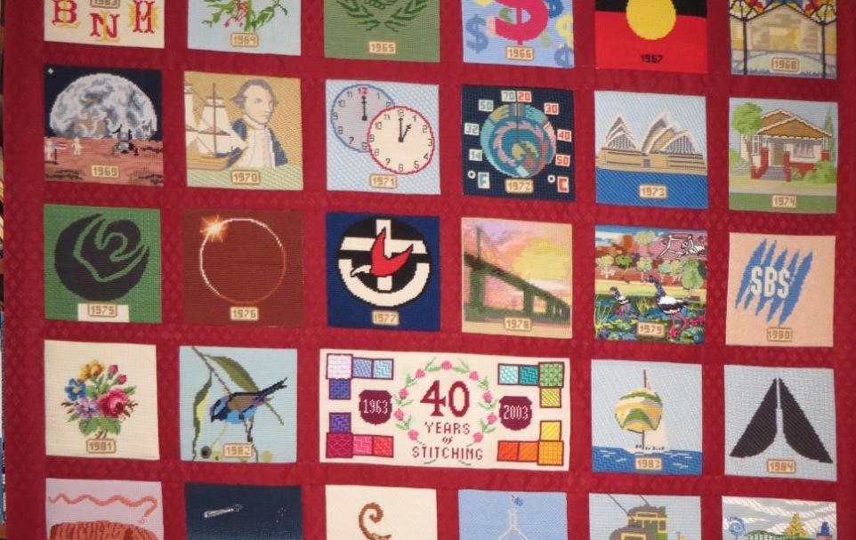 Detail of a textile wall hanging comprising a variety of pictures in squares