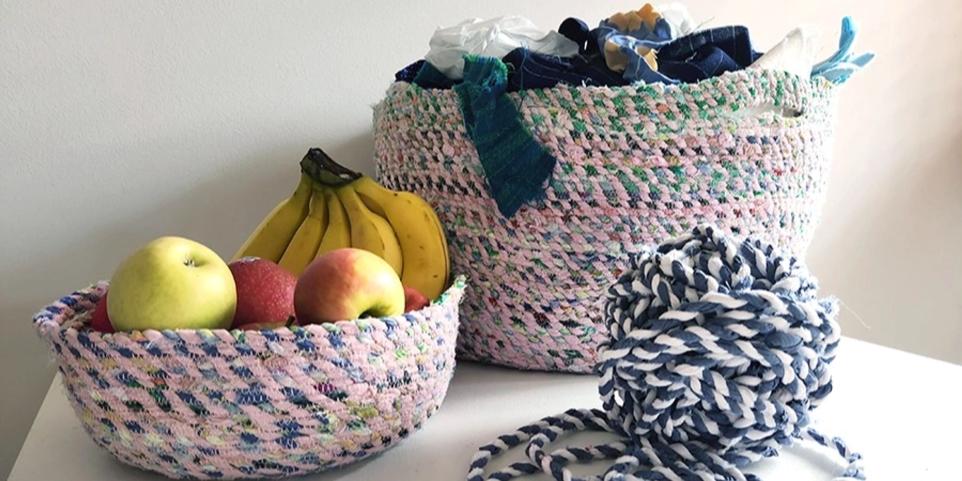 Picture of two woven baskets, one with fruit in it and the other with scrap material. 