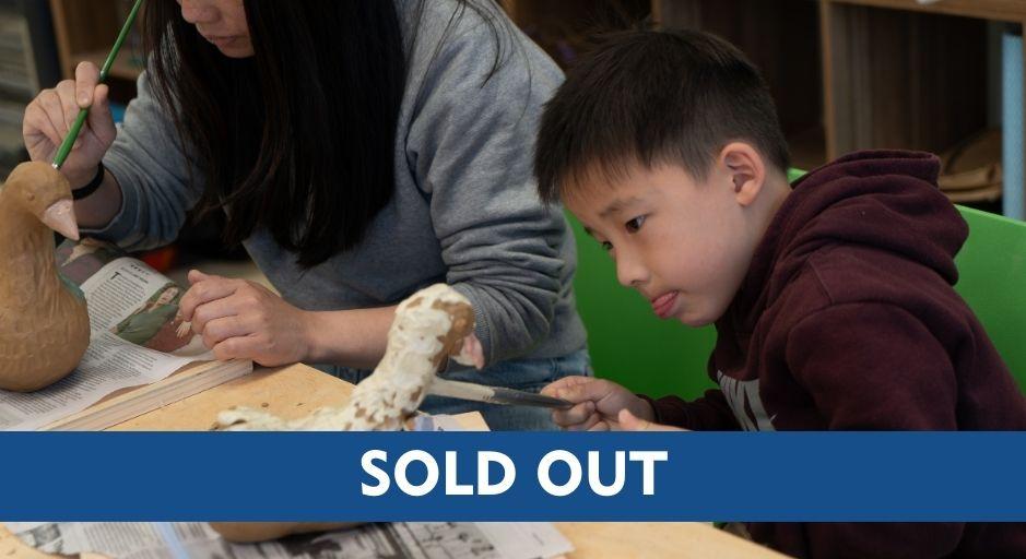 Child and parent hand building with clay including a sold-out text overlay