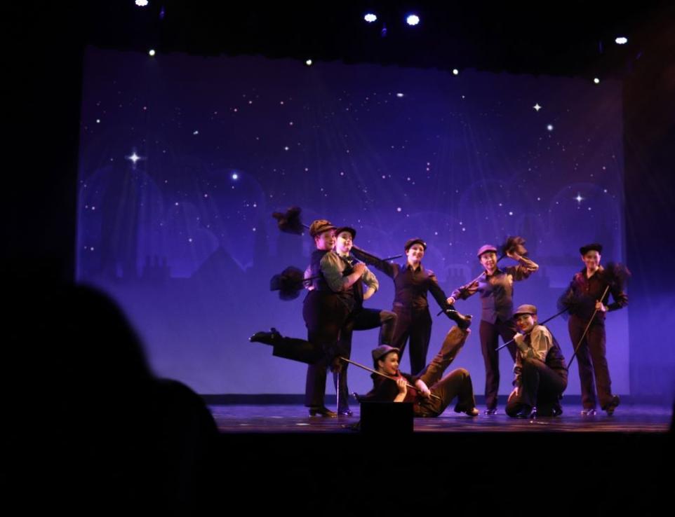 Kids dressed a chimney sweeps performing on a stage