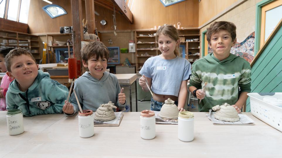 children painting ceramic art works