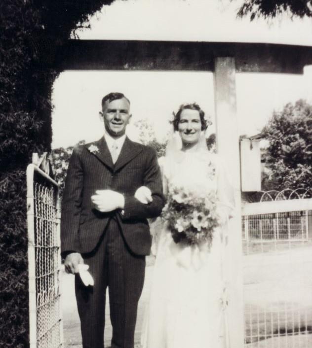 Black and white photo of wedding couple linking arms