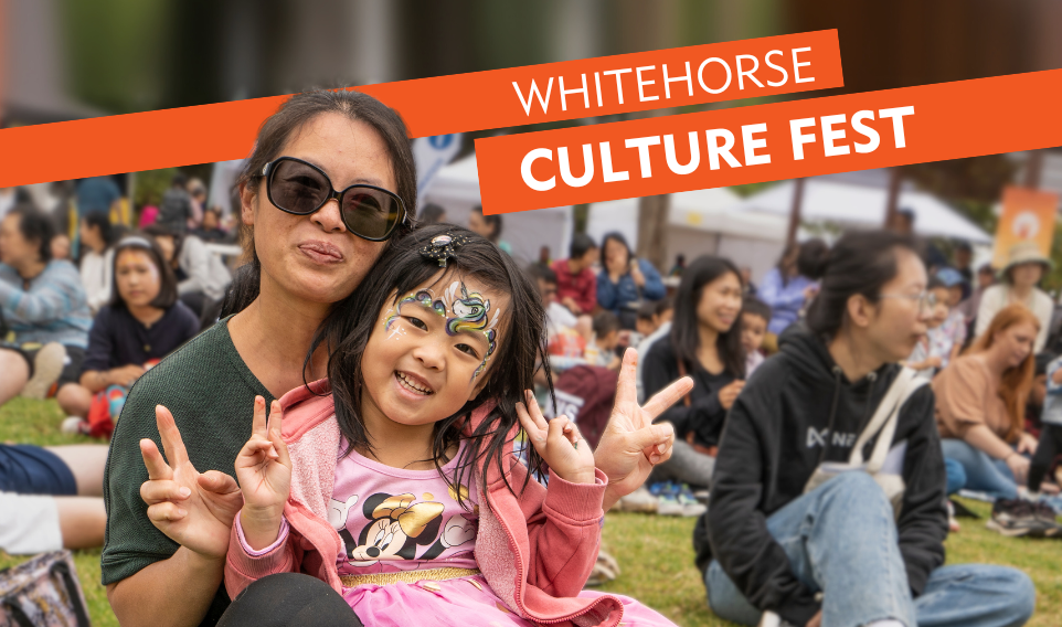 Women and child smiling at the camera holding up their hands with the peace sign. Banner text reads "whitehorse Culture fest"