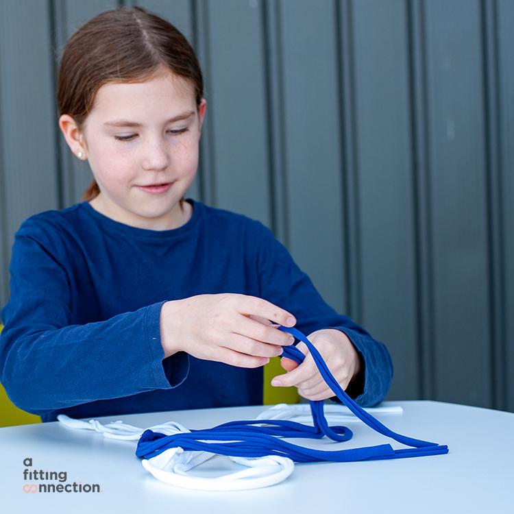 child using upcycled t-shirts to make keyrings 
