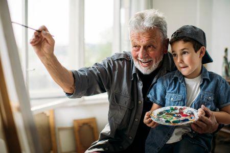 Grand parent and child in painting workshop