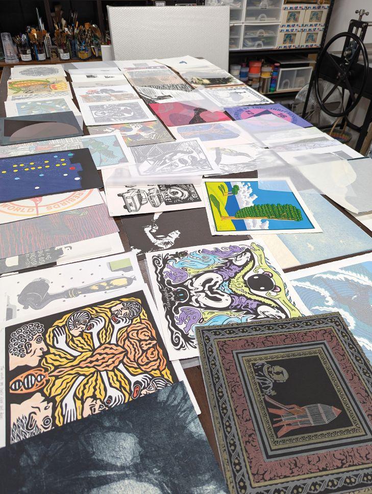 Photograph of a table laid out with artist made prints