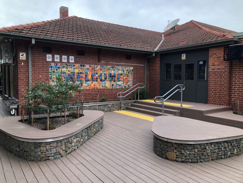 Brick building with a welcome sign at the entry.