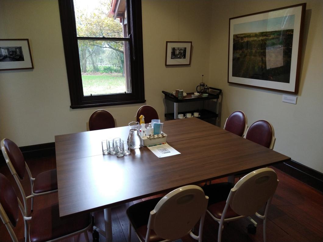 garden view room with square table seating eight people and tea trolley