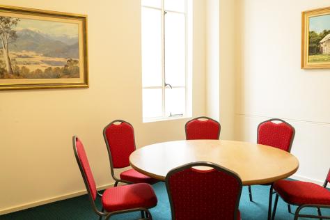 The Box Hill Town Hall's Esther Poelman Room set up with chairs and a round table
