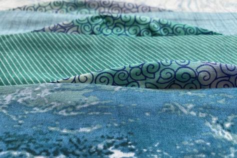 Close up of shades of green quilt fabric.