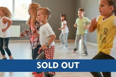 children dancing with sold out text overlay