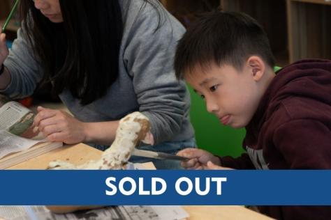Child and parent hand building with clay including a sold-out text overlay