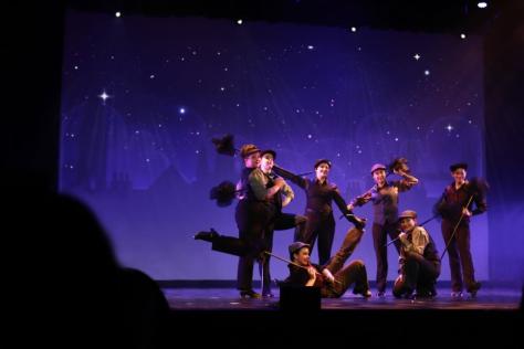 Kids dressed a chimney sweeps performing on a stage