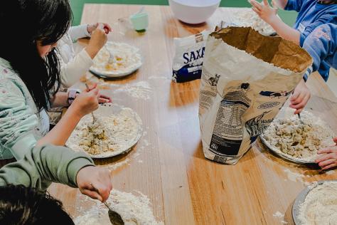 children stiring mixture in kids cooking class at Strathdon House