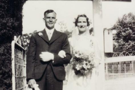 Black and white photo of wedding couple linking arms