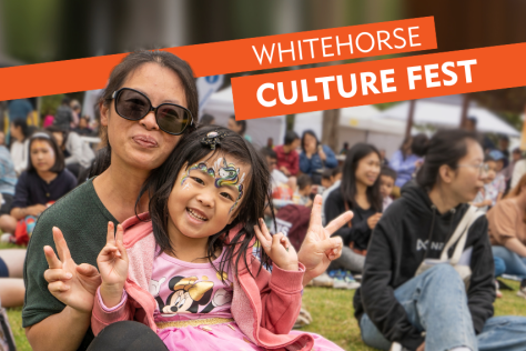 Women and child smiling at the camera holding up their hands with the peace sign. Banner text reads "whitehorse Culture fest"