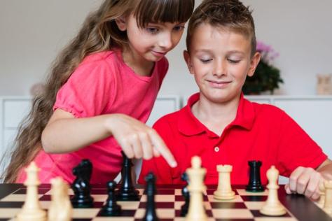children playing board game together