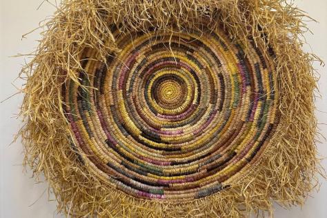 Round fibre weaving with a grass fringe.