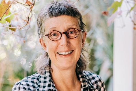 Portrait of a woman in a check shirt.