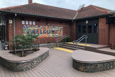 Brick building with a welcome sign at the entry.