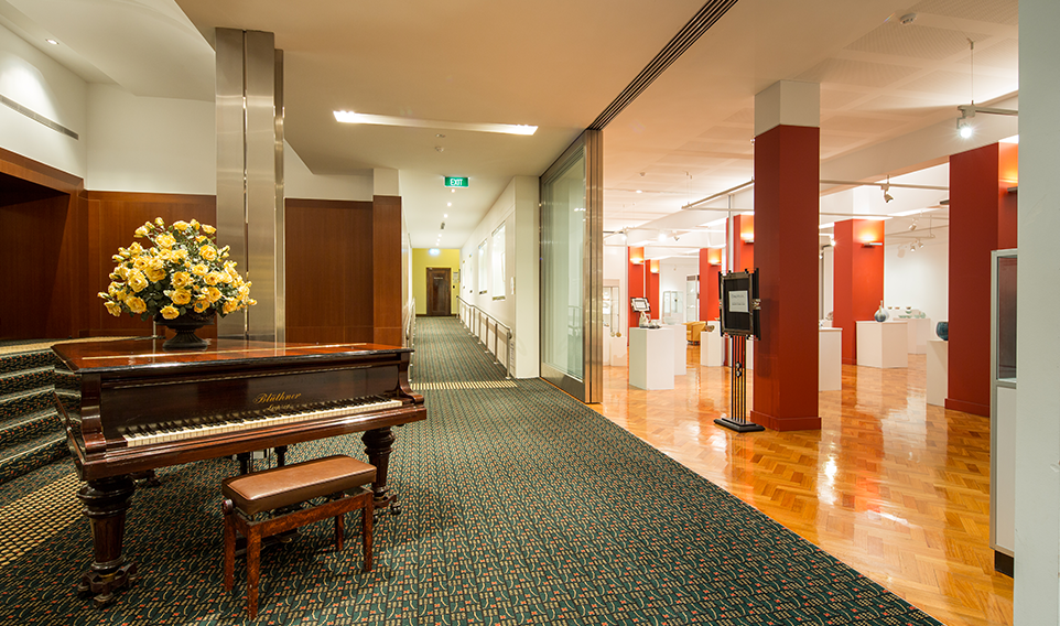 piano on left and exhibition space on right of The All Nations foyer